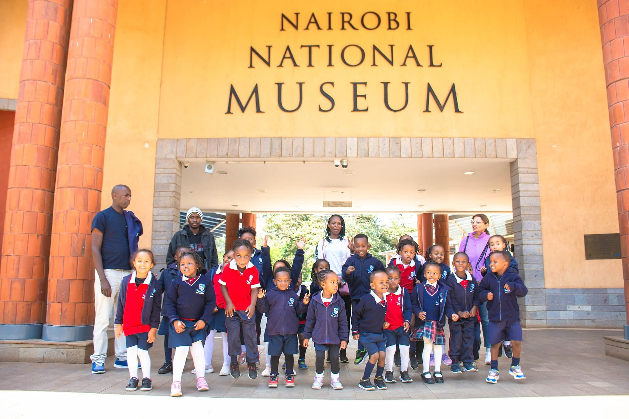 A class and their teachers on the steps of the Nairobi National Museum