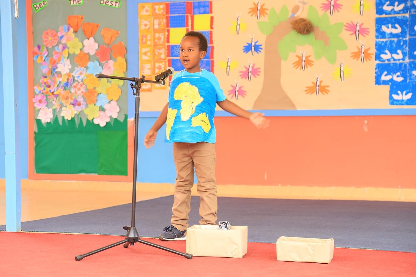 A learner speaking confidently at a microphone